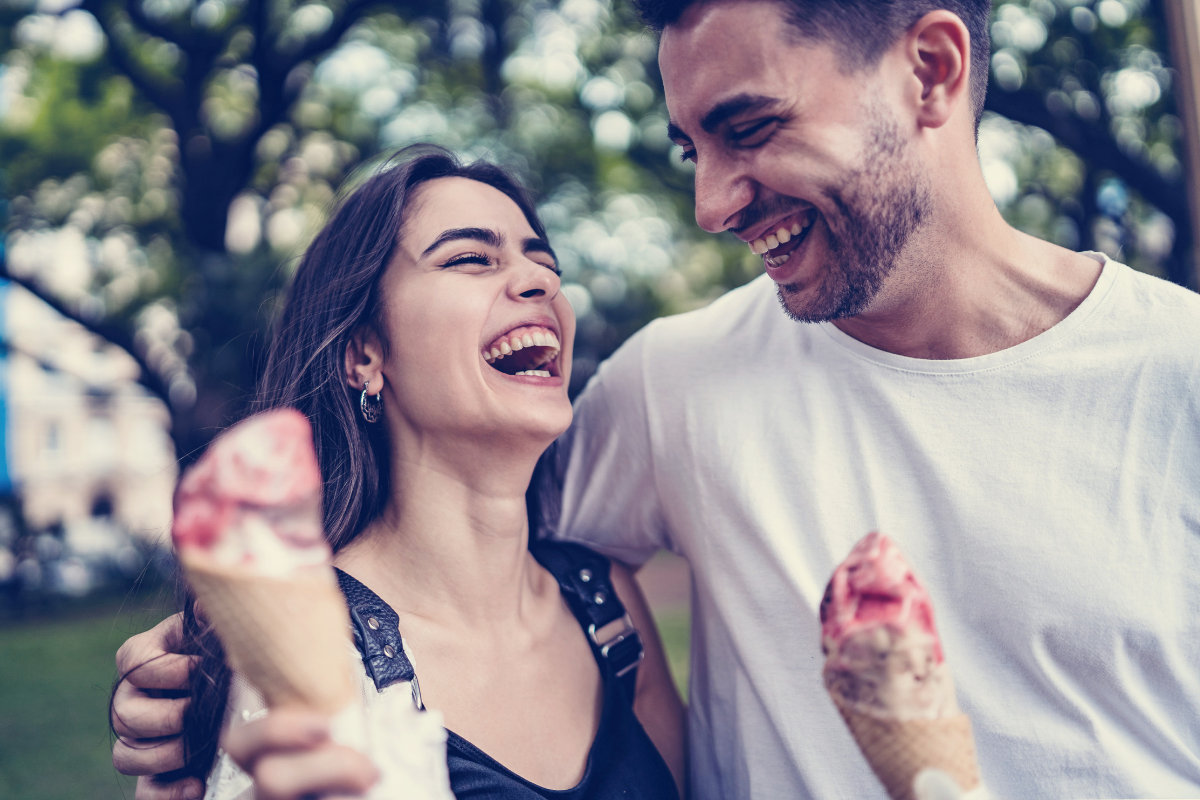 A happy couple enjoying a lighthearted moment, reflecting the joy of community life.