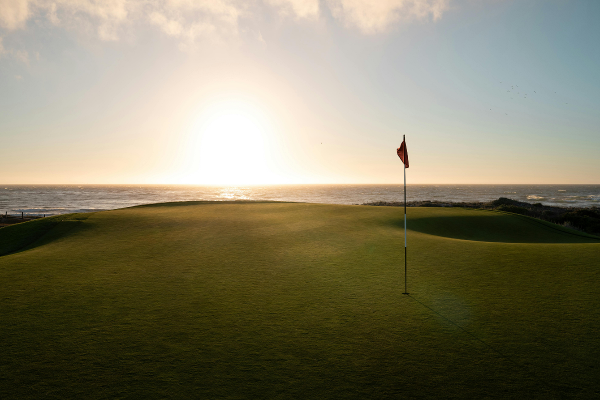 Golf course at One Hacienda Pinilla winding through tropical dry forest toward the Pacific Ocean